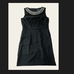 Little black dress with decorated collar.